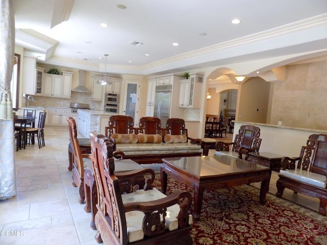 4526 Katherine Ave, Sherman Oaks, CA 91423 - living room featuring arched walkways, stone tile floors, crown molding, and recessed lighting