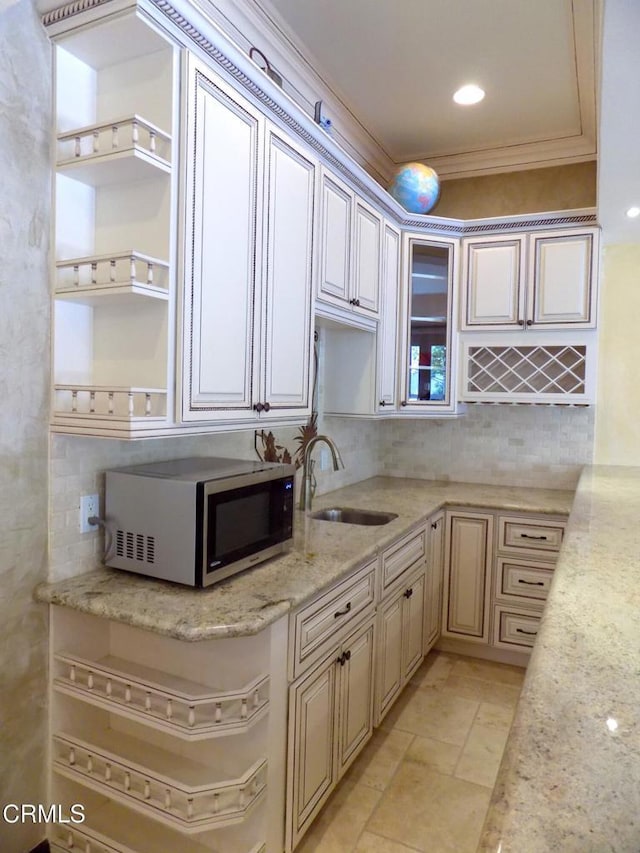 4526 Katherine Ave, Sherman Oaks, CA 91423 - kitchen featuring stainless steel microwave, open shelves, backsplash, light stone countertops, and ornamental molding