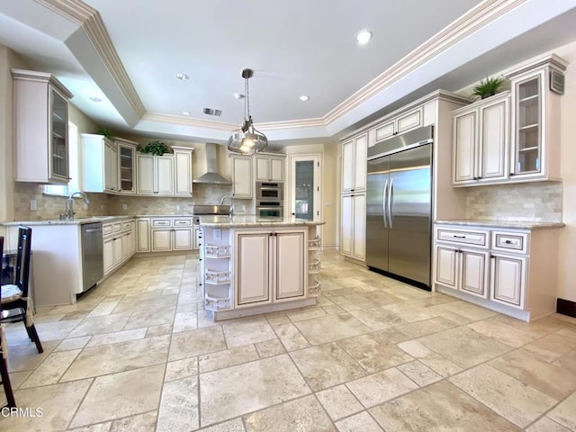 4526 Katherine Ave, Sherman Oaks, CA 91423 - kitchen featuring appliances with stainless steel finishes, stone tile floors, wall chimney range hood, a raised ceiling, and decorative backsplash