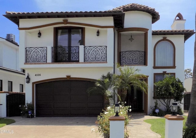 4526 Katherine Ave, Sherman Oaks, CA 91423 - mediterranean / spanish house with driveway, stucco siding, a garage, and a chimney