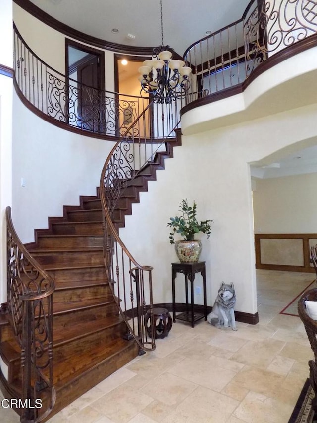 4526 Katherine Ave, Sherman Oaks, CA 91423 - stairway featuring a chandelier, a high ceiling, and stone tile flooring