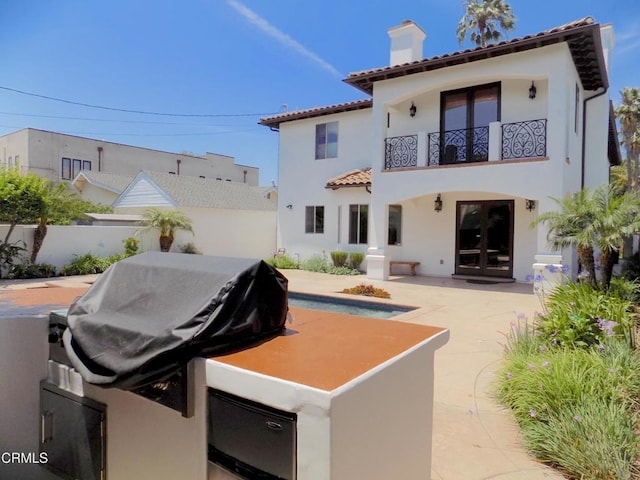 4526 Katherine Ave, Sherman Oaks, CA 91423 - back of house featuring a balcony, a chimney, a tile roof, stucco siding, and a patio area