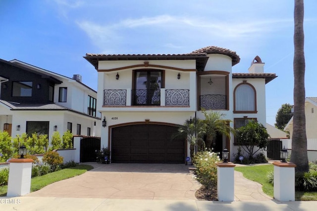 4526 Katherine Ave, Sherman Oaks, CA 91423 - mediterranean / spanish house with a balcony, stucco siding, driveway, and a tiled roof