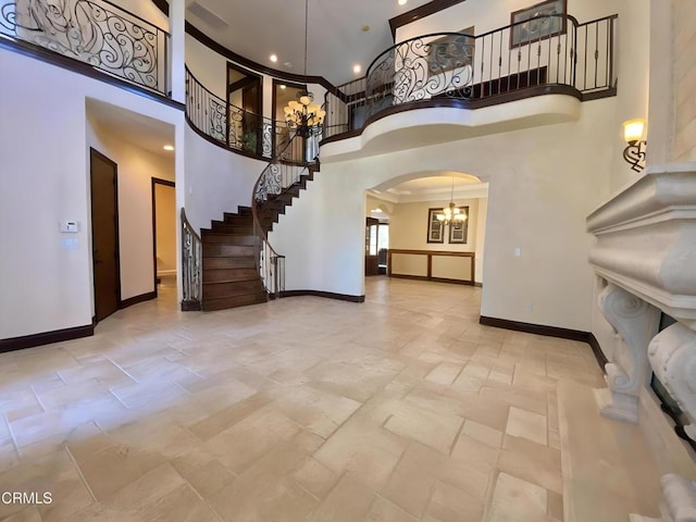 4526 Katherine Ave, Sherman Oaks, CA 91423 - foyer featuring a towering ceiling, arched walkways, stairway, a chandelier, and crown molding
