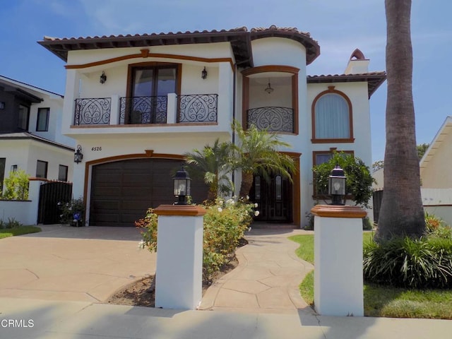 4526 Katherine Ave, Sherman Oaks, CA 91423 - mediterranean / spanish-style house with concrete driveway, a balcony, stucco siding, a tile roof, and a garage