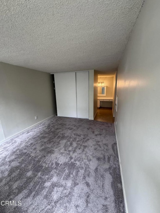 3700 Dean Dr Unit 1301, Ventura, CA 93003 - unfurnished bedroom with a textured ceiling, carpet, and a closet