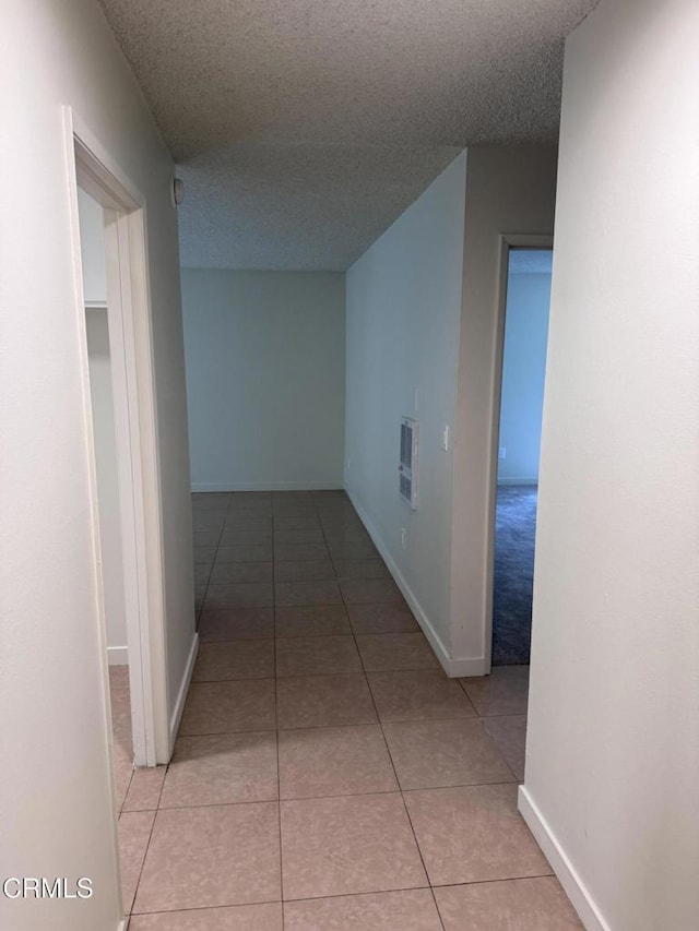 3700 Dean Dr Unit 1301, Ventura, CA 93003 - corridor with light tile patterned flooring, a textured ceiling, and heating unit