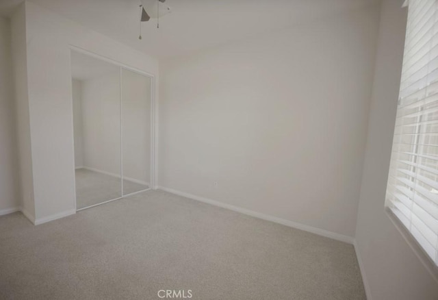 25382 Rocking Horse Ct, Menifee, CA 92584 - unfurnished bedroom featuring carpet floors, a closet, and a ceiling fan