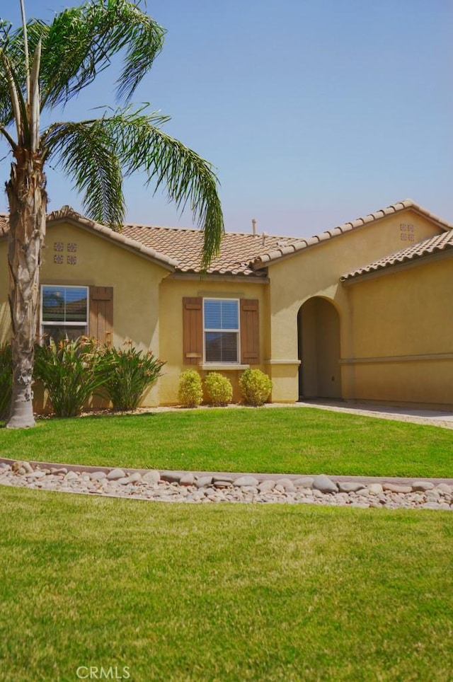 25382 Rocking Horse Ct, Menifee, CA 92584 - mediterranean / spanish-style house with a garage, stucco siding, a tile roof, and a front lawn