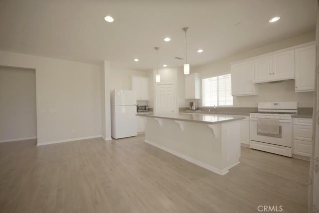 25382 Rocking Horse Ct, Menifee, CA 92584 - kitchen featuring white appliances, a breakfast bar area, a center island, white cabinets, and under cabinet range hood