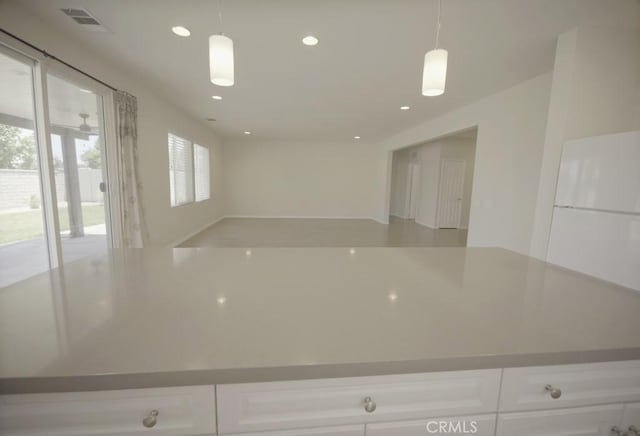 25382 Rocking Horse Ct, Menifee, CA 92584 - kitchen with white cabinets, decorative light fixtures, recessed lighting, and open floor plan