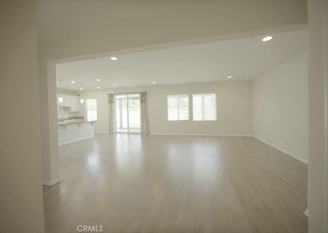 25382 Rocking Horse Ct, Menifee, CA 92584 - unfurnished living room with recessed lighting and wood finished floors