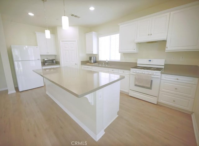 25382 Rocking Horse Ct, Menifee, CA 92584 - kitchen with white appliances, white cabinetry, light wood-style floors, a center island, and under cabinet range hood