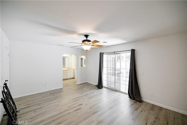 3807 Paula Ln, Lancaster, CA 93535 - spare room with arched walkways, light wood-style floors, and a ceiling fan