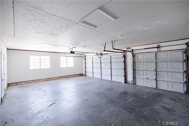 3807 Paula Ln, Lancaster, CA 93535 - garage featuring a garage door opener and baseboards