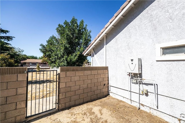 3807 Paula Ln, Lancaster, CA 93535 - view of property exterior featuring stucco siding and a gate
