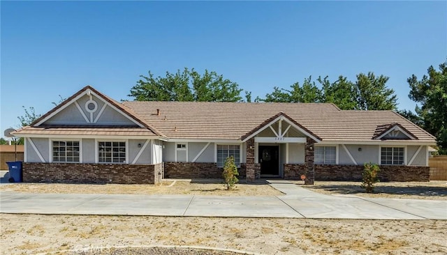 3807 Paula Ln, Lancaster, CA 93535 - view of front of home with stucco siding, brick siding, and a tile roof