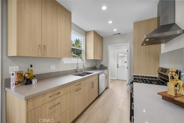 6820 Jellico Ave, Van Nuys, CA 91406 - kitchen featuring wall chimney range hood, light brown cabinets, stainless steel appliances, light wood-style floors, and light countertops