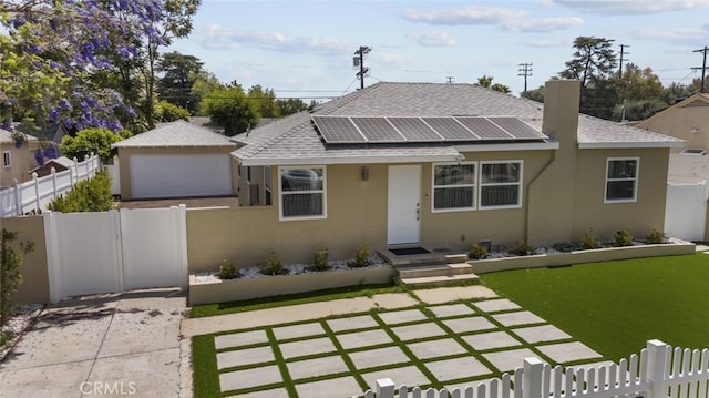 6820 Jellico Ave, Van Nuys, CA 91406 - bungalow-style home featuring stucco siding, solar panels, a shingled roof, and a detached garage