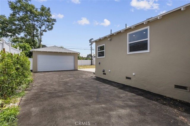 6820 Jellico Ave, Van Nuys, CA 91406 - view of home's exterior featuring crawl space, an outbuilding, a detached garage, and stucco siding