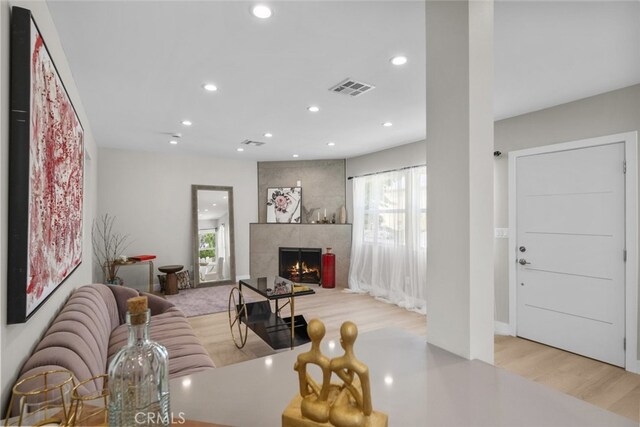 6820 Jellico Ave, Van Nuys, CA 91406 - living room featuring healthy amount of natural light, recessed lighting, light wood-style flooring, and a high end fireplace