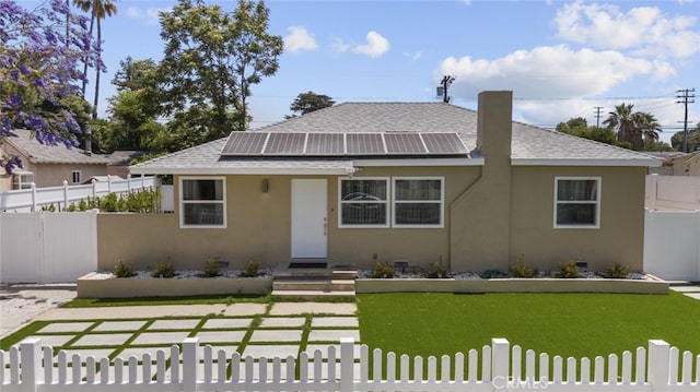 6820 Jellico Ave, Van Nuys, CA 91406 - bungalow-style home with a shingled roof, a fenced front yard, roof mounted solar panels, and stucco siding