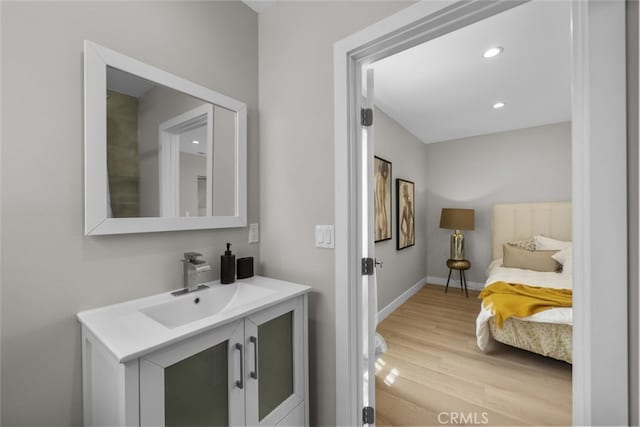 6820 Jellico Ave, Van Nuys, CA 91406 - bathroom featuring vanity, wood finished floors, and recessed lighting