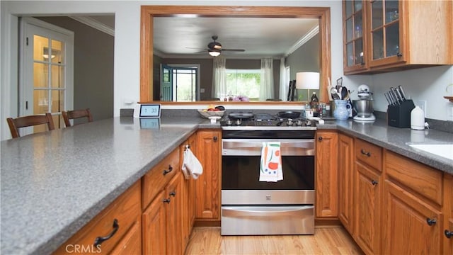 412 N Mallagh St, Nipomo, CA 93444 - kitchen featuring stainless steel gas range oven, ornamental molding, brown cabinetry, and glass insert cabinets