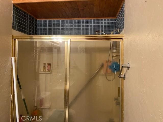 7 Westwood Way, Oroville, CA 95966 - bathroom with a stall shower, wooden ceiling, and a textured wall