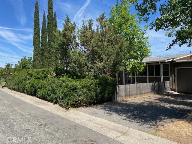 7 Westwood Way, Oroville, CA 95966 - view of side of home featuring driveway, an attached garage, and a sunroom