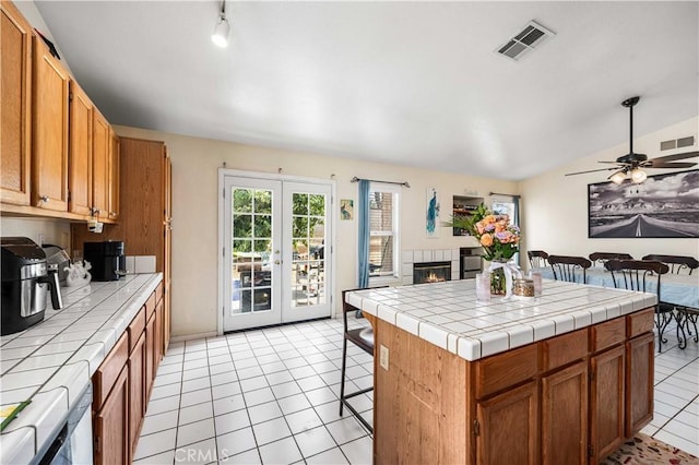 3038 Kaylyn St, Lancaster, CA 93535 - kitchen with tile countertops, open floor plan, french doors, and light tile patterned floors
