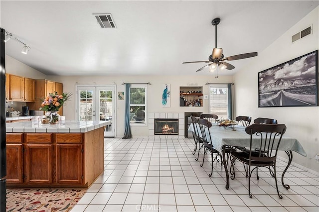 3038 Kaylyn St, Lancaster, CA 93535 - kitchen featuring tile counters, healthy amount of natural light, a ceiling fan, and a fireplace