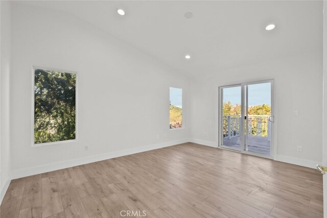 40946 Via Tranqilo, Palmdale, CA 93551 - unfurnished room featuring healthy amount of natural light, wood finished floors, vaulted ceiling, and recessed lighting