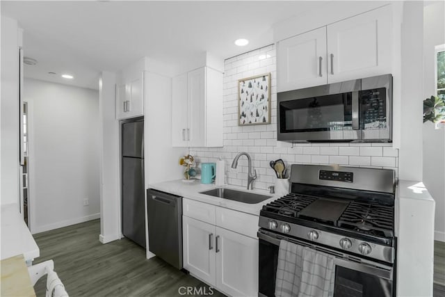 5924 Gran Paseo Way, Atascadero, CA 93422 - kitchen with stainless steel appliances, backsplash, white cabinets, dark wood-style flooring, and light countertops