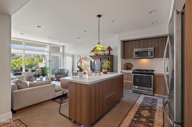 482 S Arroyo Pkwy Unit 405, Pasadena, CA 91105 - kitchen with stainless steel appliances, modern cabinets, open floor plan, brown cabinets, and recessed lighting