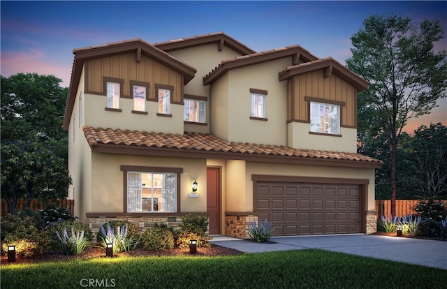 2042 Casey Ln, Los Banos, CA 93635 - view of front facade featuring driveway, an attached garage, a tile roof, stone siding, and stucco siding