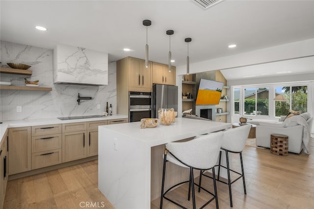 25302 Posada Ln, Mission Viejo, CA 92691 - kitchen featuring stainless steel appliances, a breakfast bar, backsplash, open shelves, and light wood-style floors