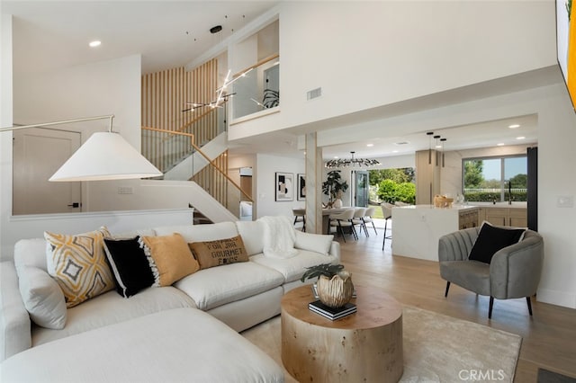 25302 Posada Ln, Mission Viejo, CA 92691 - living room featuring wood finished floors, stairs, a high ceiling, and recessed lighting