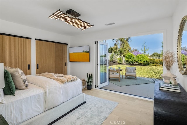 25302 Posada Ln, Mission Viejo, CA 92691 - bedroom with access to exterior, wood finished floors, and two closets