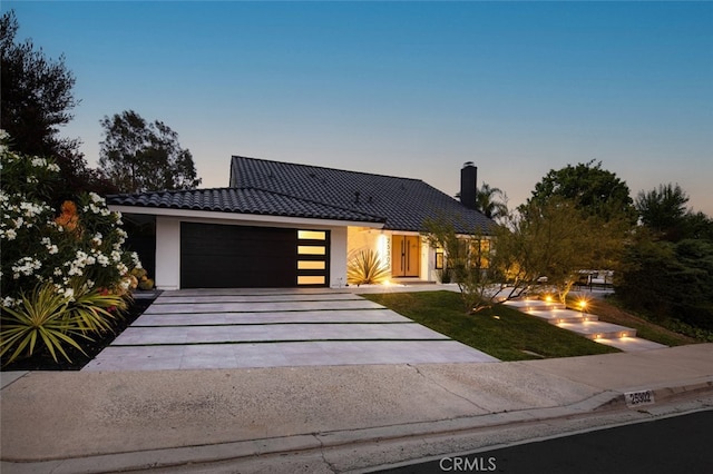 25302 Posada Ln, Mission Viejo, CA 92691 - contemporary home featuring a tiled roof, driveway, a garage, stucco siding, and a fire pit