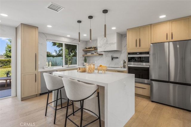 25302 Posada Ln, Mission Viejo, CA 92691 - kitchen with appliances with stainless steel finishes, light brown cabinets, tasteful backsplash, light countertops, and a center island