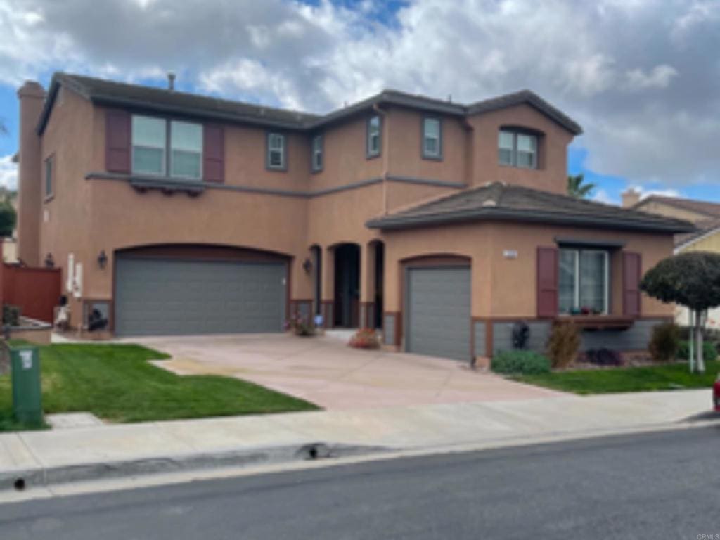 5191 Cobalt Way, Oceanside, CA 92057 - view of front of house featuring an attached garage, stucco siding, and driveway