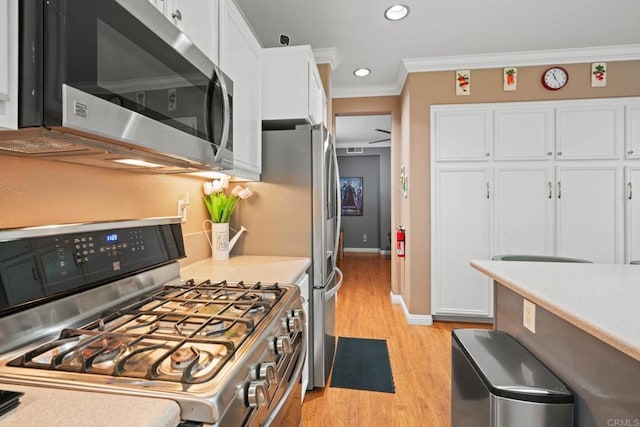 5191 Cobalt Way, Oceanside, CA 92057 - kitchen with appliances with stainless steel finishes, white cabinetry, ornamental molding, light wood-type flooring, and light countertops
