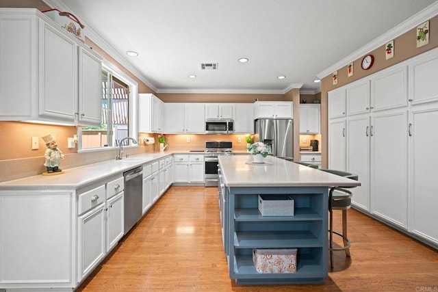 5191 Cobalt Way, Oceanside, CA 92057 - kitchen with stainless steel appliances, open shelves, ornamental molding, white cabinets, and light countertops