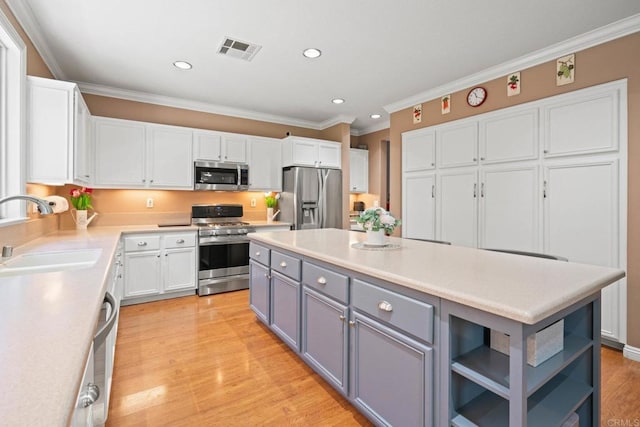 5191 Cobalt Way, Oceanside, CA 92057 - kitchen featuring appliances with stainless steel finishes, gray cabinets, white cabinets, ornamental molding, and recessed lighting