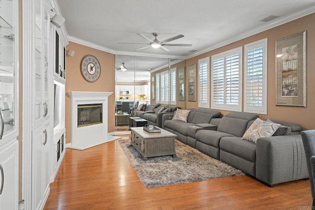 5191 Cobalt Way, Oceanside, CA 92057 - living area featuring a ceiling fan, ornamental molding, light wood-style floors, and a glass covered fireplace