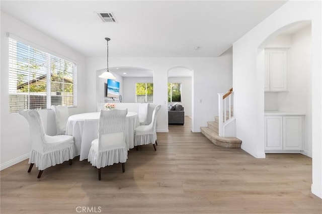 15216 Masline St, Baldwin Park, CA 91706 - dining area featuring arched walkways, light wood finished floors, and healthy amount of natural light