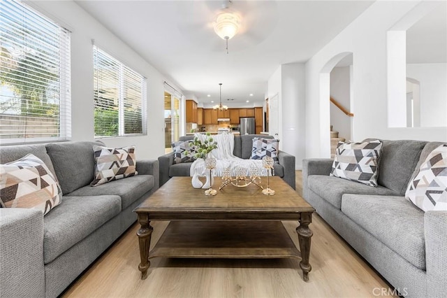 15216 Masline St, Baldwin Park, CA 91706 - living area featuring light wood-type flooring, stairs, arched walkways, and a ceiling fan