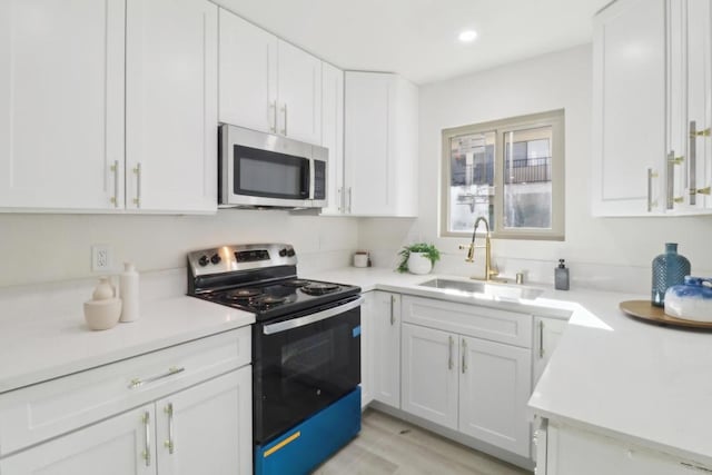 3535 Monroe Ave Unit 5, San Diego, CA 92116 - kitchen featuring appliances with stainless steel finishes, white cabinetry, light countertops, and recessed lighting