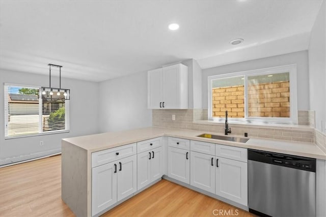 37727 Dixie Dr, Palmdale, CA 93550 - kitchen with stainless steel dishwasher, a peninsula, white cabinets, light countertops, and light wood-type flooring